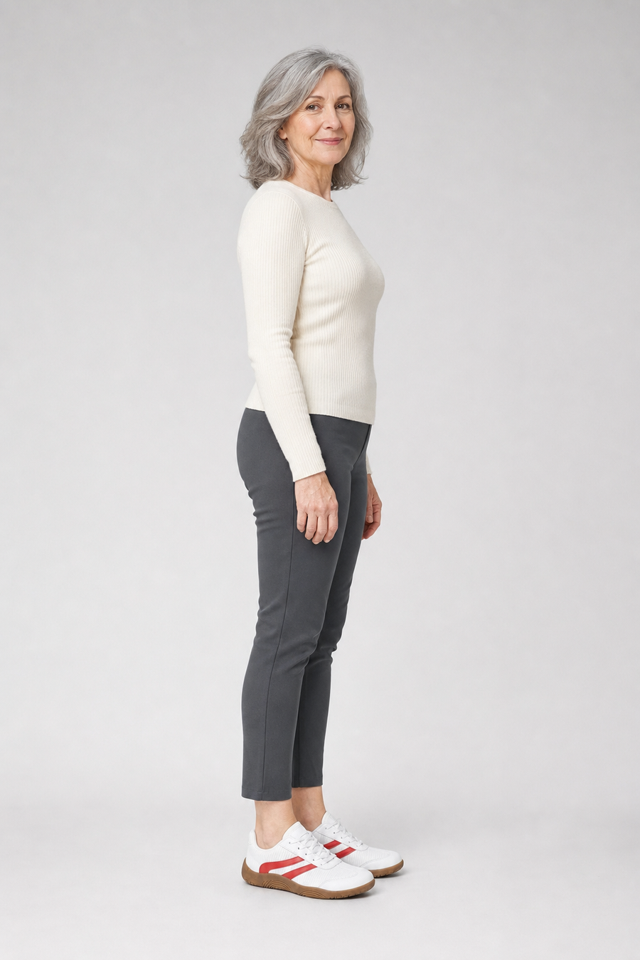 A woman standing in the Dash shoes, side view showing her hips, knees, ankles and the ball of her foot