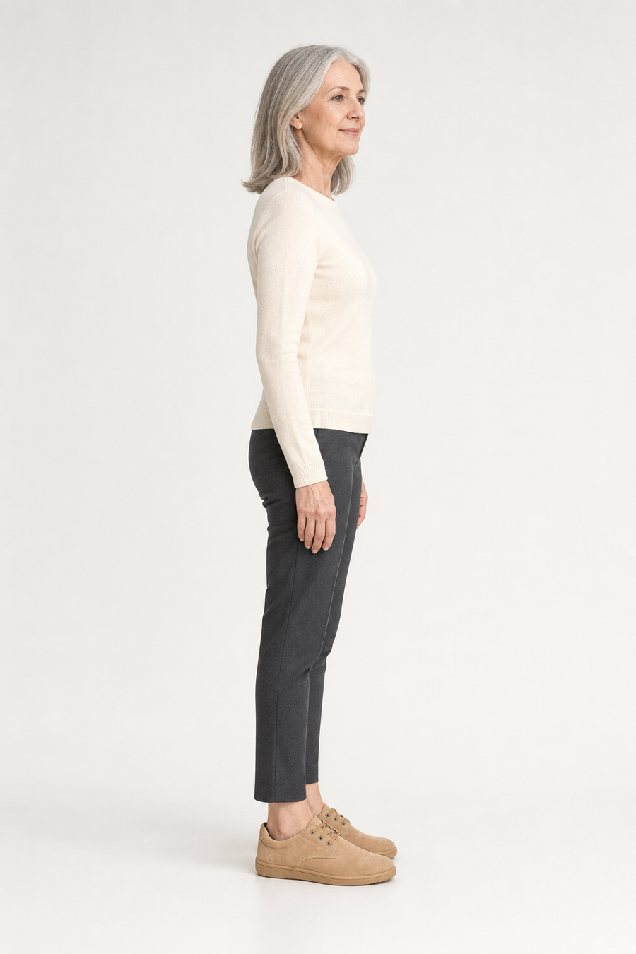 A woman standing in the Haven shoes, side view showing her hips, knees, ankles and the ball of her foot