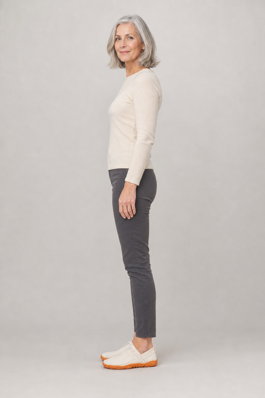 A woman standing in the Rapids shoes, side view showing her hips, knees, ankles and the ball of her foot