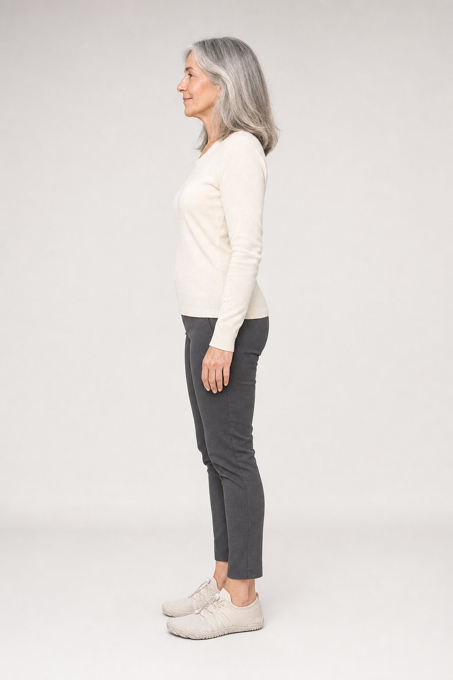 A woman standing in the Terra shoes, side view showing her hips, knees, ankles and the ball of her foot