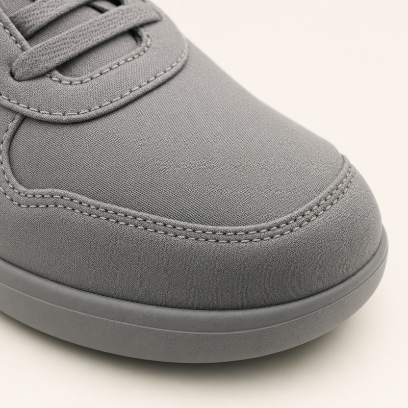 Close up of an ordinary sewn shoe upper with a raised stitched seam across the toes
